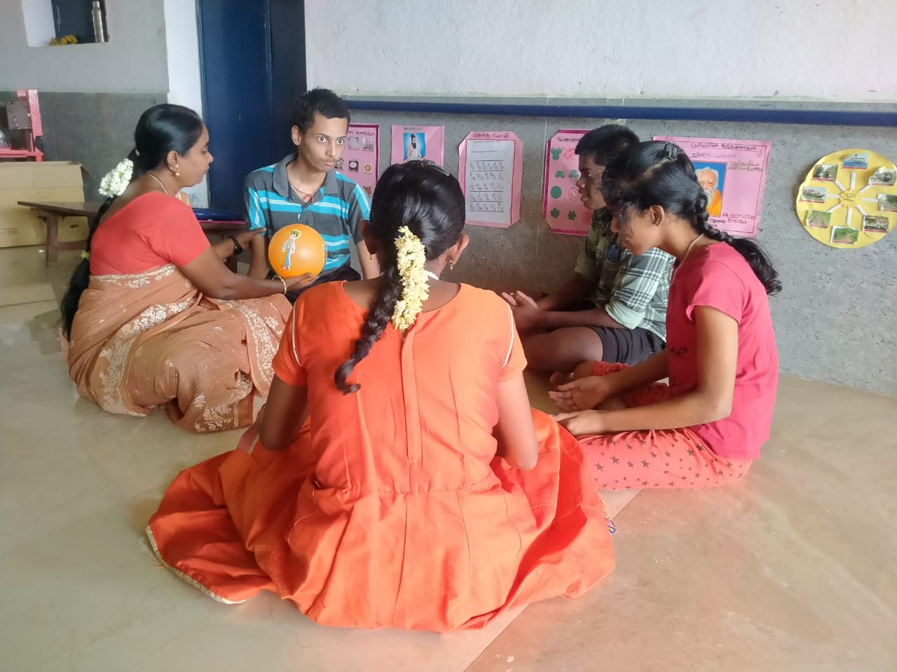 Small group therapy session with a ball